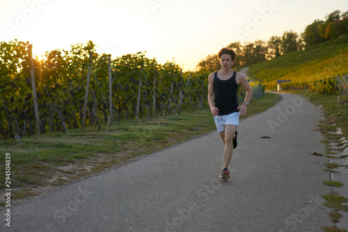 runner in shorts during sunset in nature