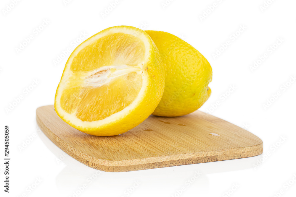 Group of two halves of fresh bright orange on bamboo cutting board isolated on white background Group of two halves of fresh bright orange on bamboo cutting board isolated on white background