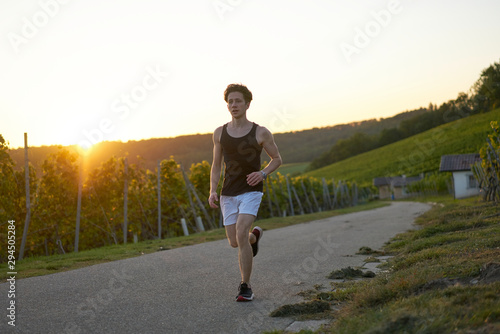 young jogger in nature during sunset