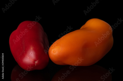 Group of two whole fresh pepper two in focus isolated on black glass photo