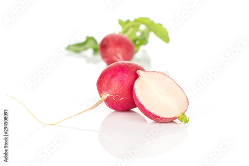 Group of two whole one half of fresh red radish isolated on white background