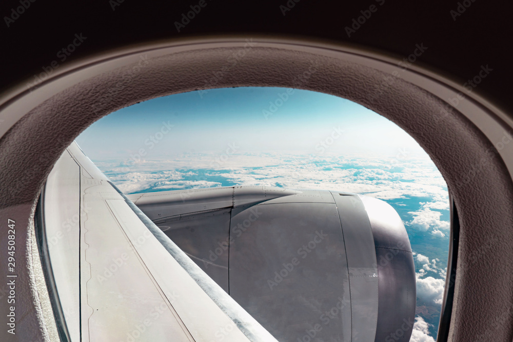 Cloudy view through the aircraft window from the seat at a plane, high at the sky, somewhere at stratosphere. Cloudy view through the aircraft window from the seat at a plane, high at the sky, somewhere at stratosphere.