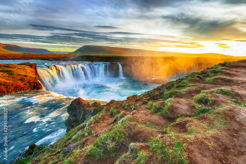 Fantastic sunrise scene of powerful Godafoss waterfall.