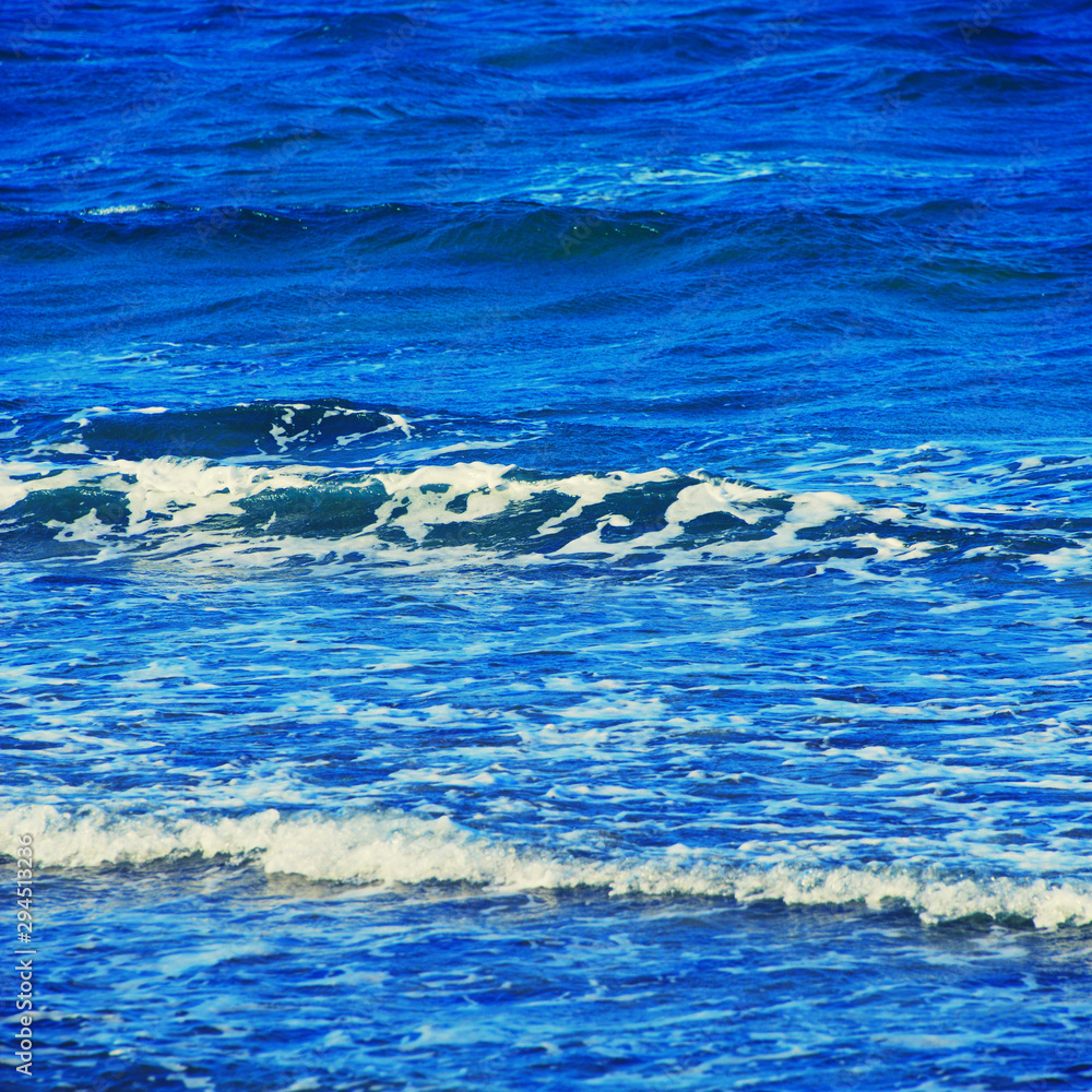 Abstract clean sea background, view on ripple foam surface of water. Deep turquoise blue ocean waves. Calm ocean water background landscape. Clear water wave texture. Marine aqua at tropical summer. Abstract clean sea background, view on ripple foam surface of water. Deep turquoise blue ocean waves. Calm ocean water background landscape. Clear water wave texture. Marine aqua at tropical summer.