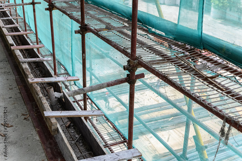 inside of an unfinished building with protection scaffolding and netting surrounde