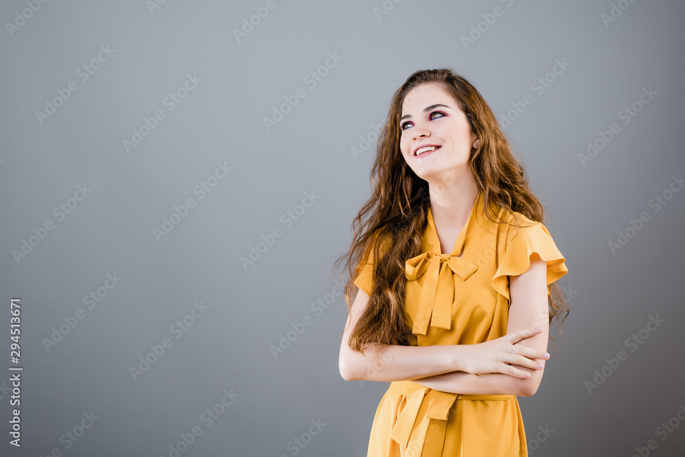pretty emotional woman smiling isolated over grey background pretty emotional woman smiling isolated over grey background