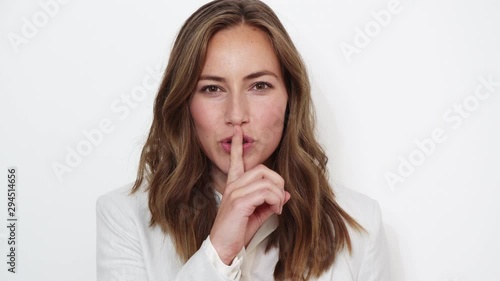Businesswoman With Finger On Lips
