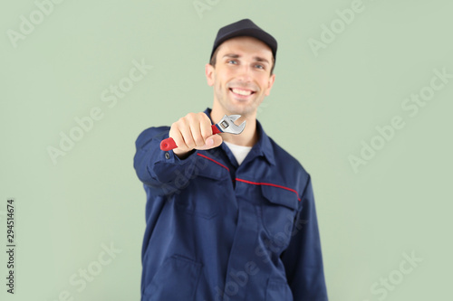 Male car mechanic on color ...