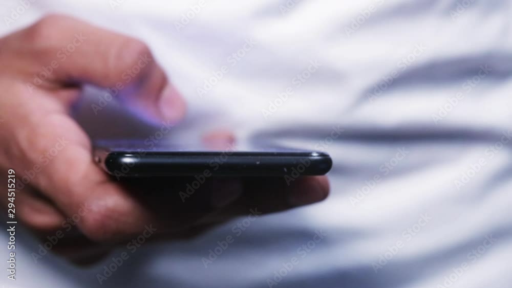 man's hand using smart phone with likes hovering over the screen man's hand using smart phone with likes hovering over the screen