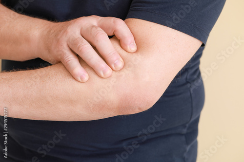 Wallpaper Mural Senior man suffering from pain in elbow on light background, closeup Torontodigital.ca