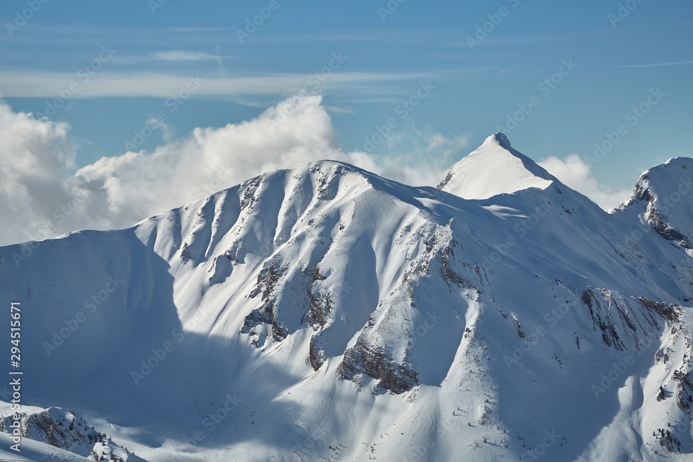 Naklejka premium Snowy mountains in winter weather with ski slopes