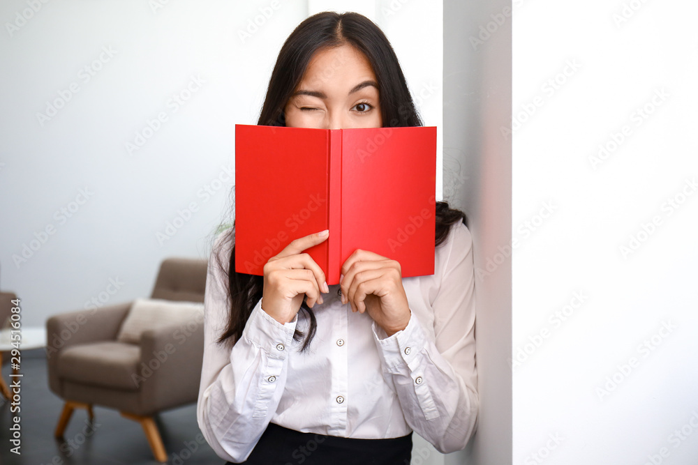 Beautiful Asian woman with book in office Beautiful Asian woman with book in office
