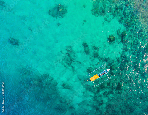 Couple snorkeling in the blue sea ocean and coral background aerial top view
