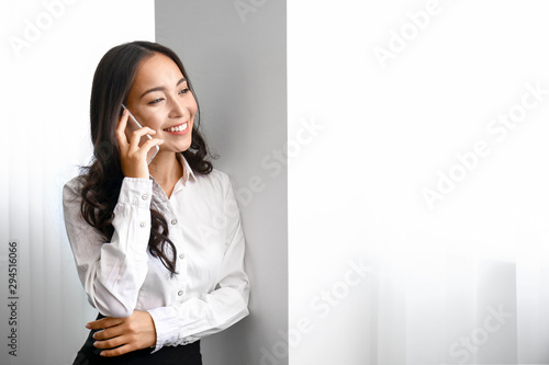 Beautiful Asian woman talki...