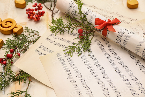 Christmas composition with music notes on table photo