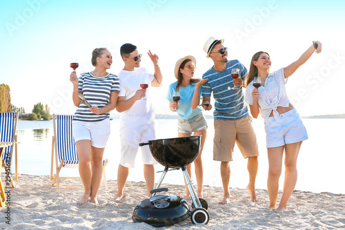 Friends taking selfie at barbecue party near river