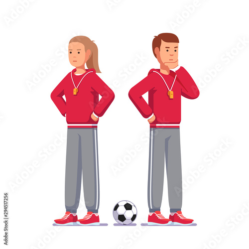 Pensive soccer coach standing next to soccer ball