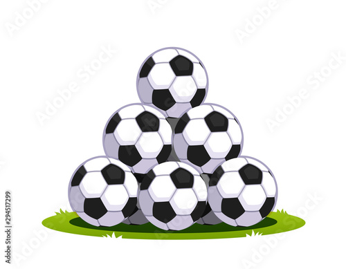 Pyramid pile of soccer footballs on green grass