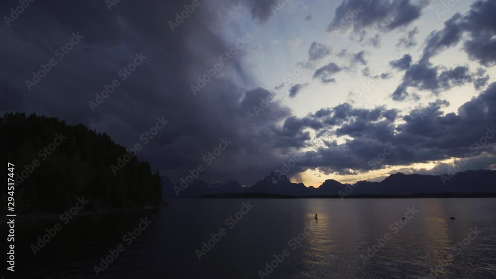 The Grand Tetons Across the Water at Sunset, With a Forest on the Left The Grand Tetons Across the Water at Sunset, With a Forest on the Left