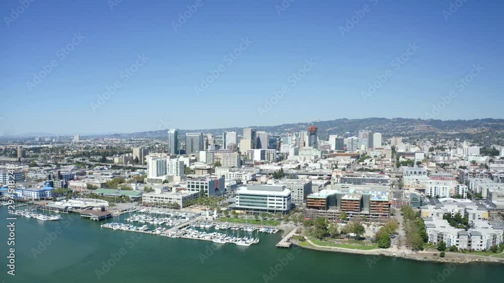 A beautiful sunny day as the camera passes over the city with bright buildings and a clear blue sky. A beautiful sunny day as the camera passes over the city with bright buildings and a clear blue sky.
