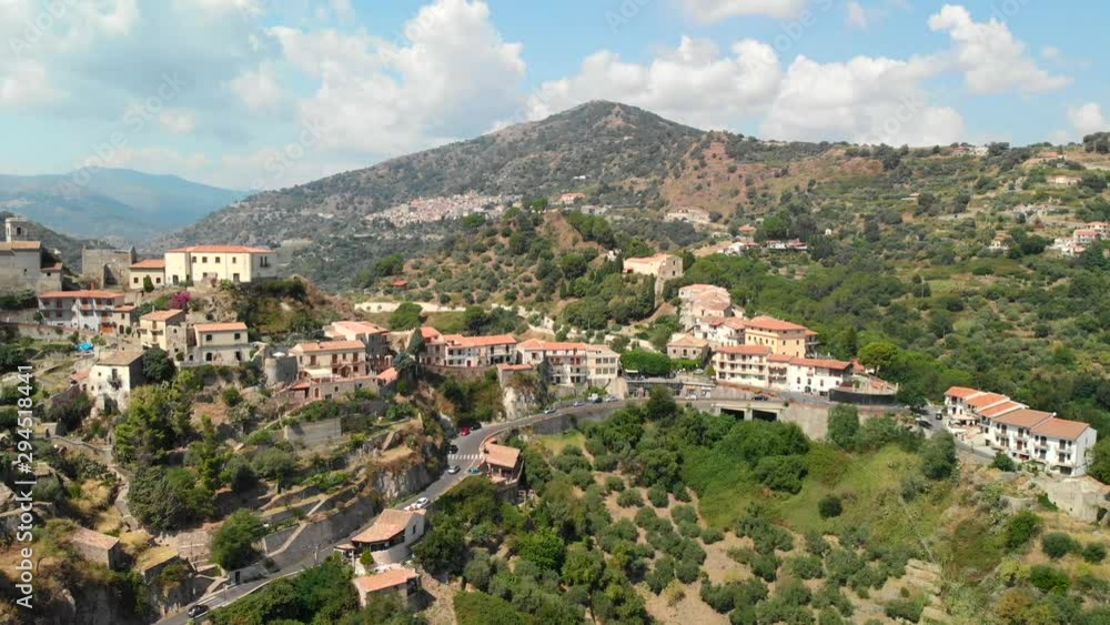 AERIAL DOLLY IN: Drone flying above the old village of Savoca in Sicily Italy, with its picturesque castle and a wonderful view of the mountains AERIAL DOLLY IN: Drone flying above the old village of Savoca in Sicily Italy, with its picturesque castle and a wonderful view of the mountains