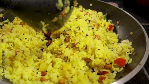 Top view of fresh Indian breakfast, Preparing Poha with veggies and ingredients in cooking pan. photo