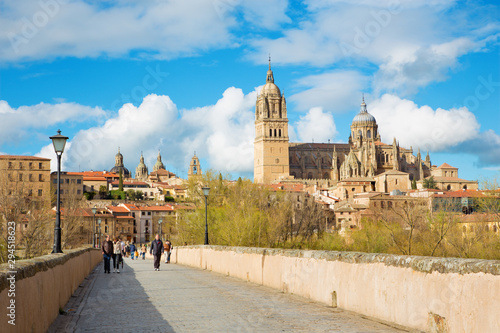 SALAMANCA, SPAIN, APRIL - 17, 2016: The Cathedral and bridge Puente Romano over the Rio Tormes river.