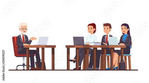 Coach speaking to business students at school desk