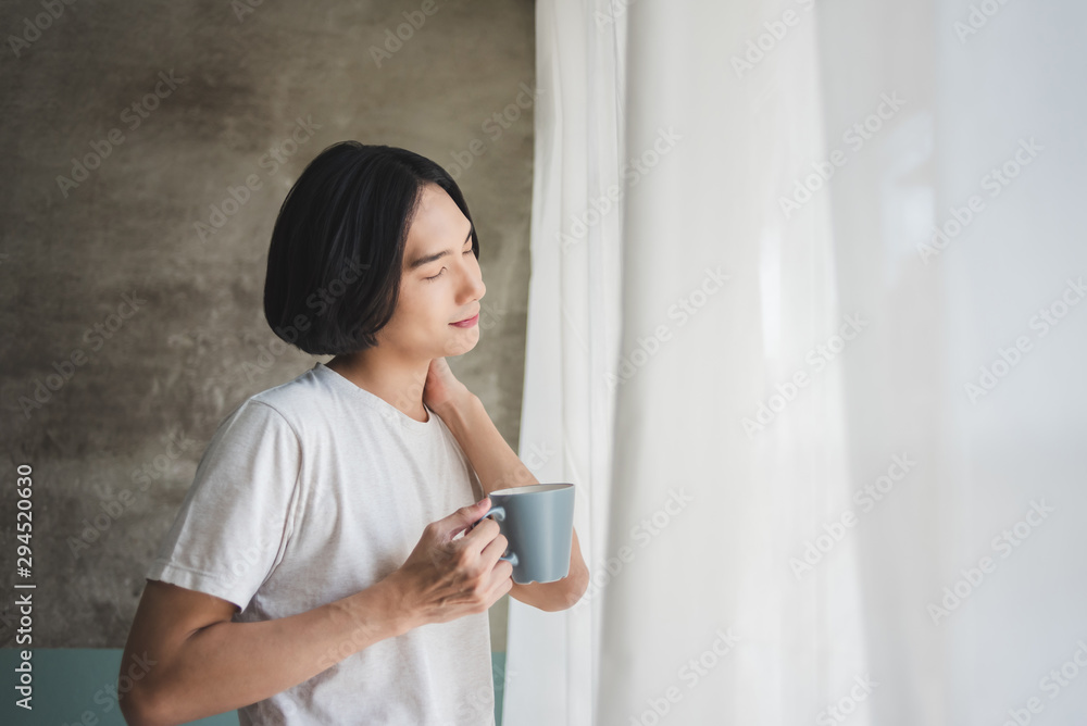 Happy Asian man relaxing and enjoying coffee on holidays. Happy Asian man relaxing and enjoying coffee on holidays.