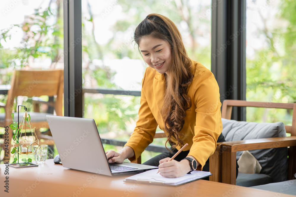 Business Attractive Asian young woman working with laptop smile and writing idea and requirement for success job outside office in coffee shop,Small Business Concept,Warm Tone Business Attractive Asian young woman working with laptop smile and writing idea and requirement for success job outside office in coffee shop,Small Business Concept,Warm Tone