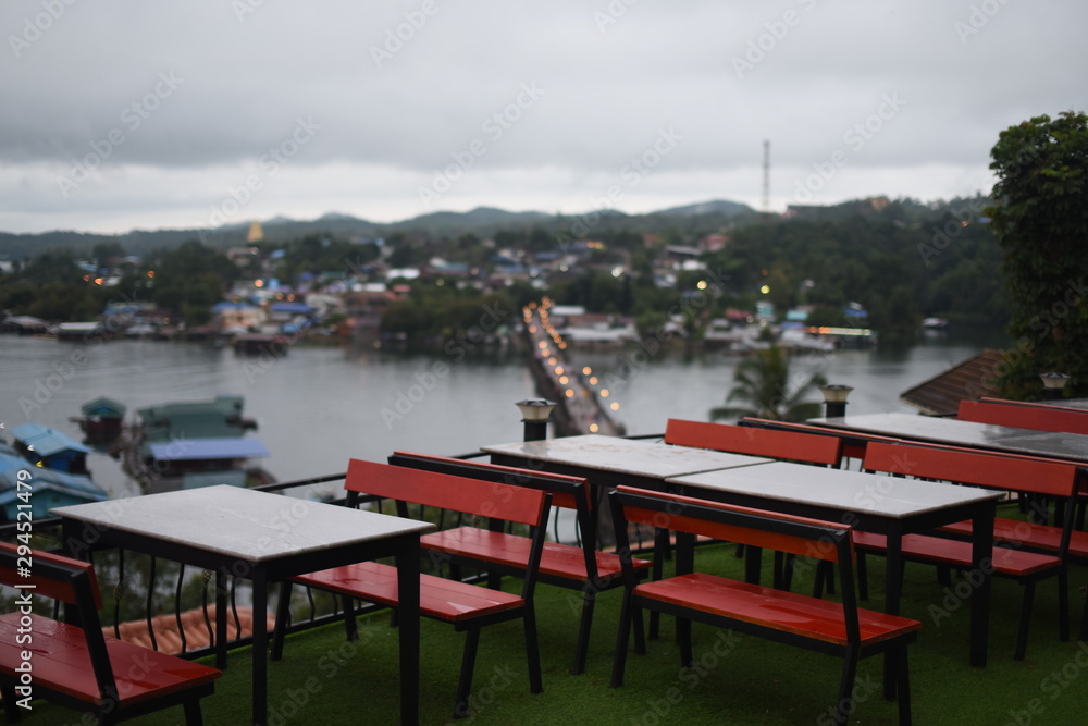 Fototapeta premium View of the river and surrounding communities of the dam near the Mon Bridge at Khao Laem Dam, Sangklaburi, Thailand.
