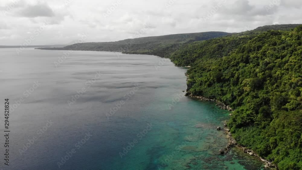aerial view of a tropical island with clear water in Vanuatu, South pacific aerial view of a tropical island with clear water in Vanuatu, South pacific