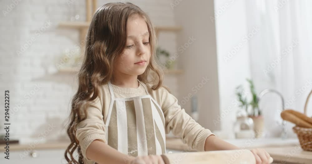 Cute caucasian girl is learning how to cook, preparing dough for cookies, dreaming of becoming a chef - childhood dream, childhood memories concept 4k Cute caucasian girl is learning how to cook, preparing dough for cookies, dreaming of becoming a chef - childhood dream, childhood memories concept 4k