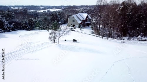Wallpaper Mural A drone, aerial, birds eye view of a child sitting on a sled getting pulled by an atv 4 wheeler with another child riding on the back.Virginia snow covered mountains and countryside seen throughout. Torontodigital.ca