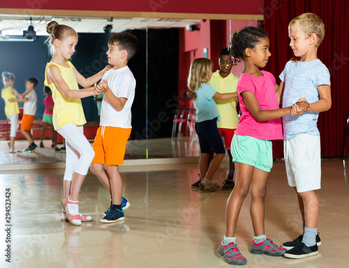 Group of joyful children dancing salsa dance