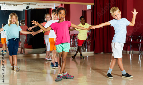 Cheery children trying dancing partner dance