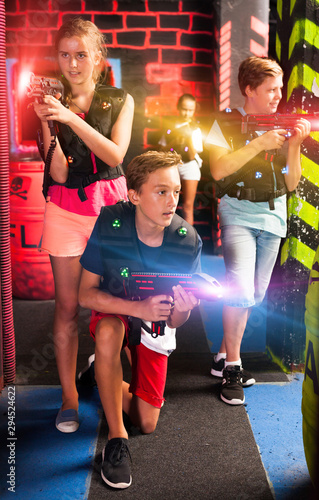 Girls and boys playing laser tag © JackF
