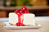 a slice of cherry cheesecake on a kitchen countertop