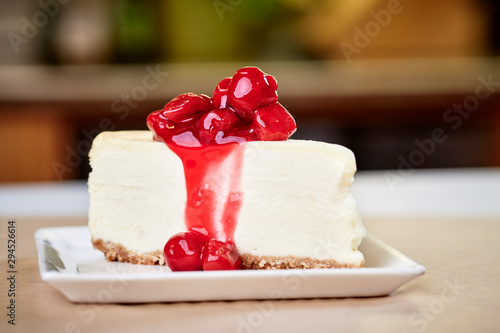 a slice of cherry cheesecake on a kitchen countertop photo