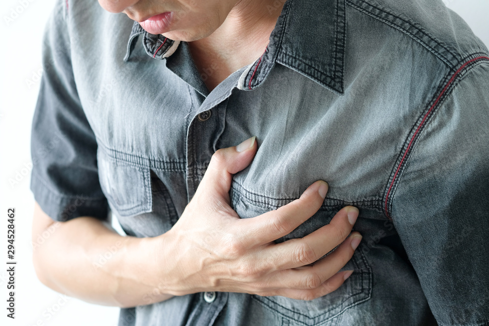 Heart attack, Man standing chest pain in the bedroom Health concept Heart attack, Man standing chest pain in the bedroom Health concept