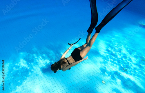 Underwater images of women diving deep