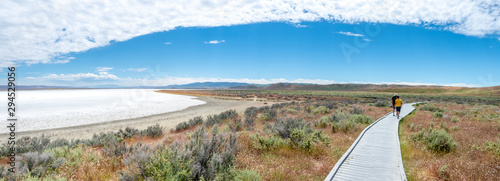 Boy and father walking at salt flat boardwalkm Soda Lake, Carizzo Plain National Monument on sunny spring day, Kern County, California, Central Valley
