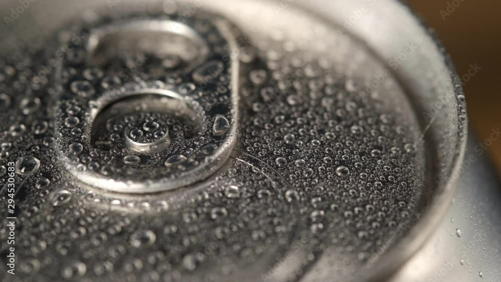Macro shot of lot of water droplets on lid of an aluminum can, beer container, chilled can of soda or cola, only from refrigerator, fresh drink, panorama of top of package, can is not open Macro shot of lot of water droplets on lid of an aluminum can, beer container, chilled can of soda or cola, only from refrigerator, fresh drink, panorama of top of package, can is not open