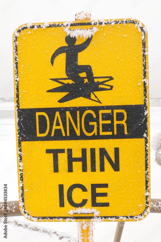 Danger Thin Ice yellow sign of warning people careful this area and have  hoarfrost stick on it, in winter season at Regina, Saskatchewan, Canada  Stock Photo