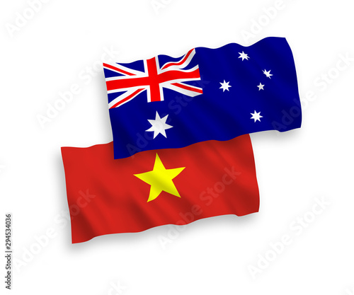 National vector fabric wave flags of Australia and Vietnam isolated on white background. 1 to 2 proportion.