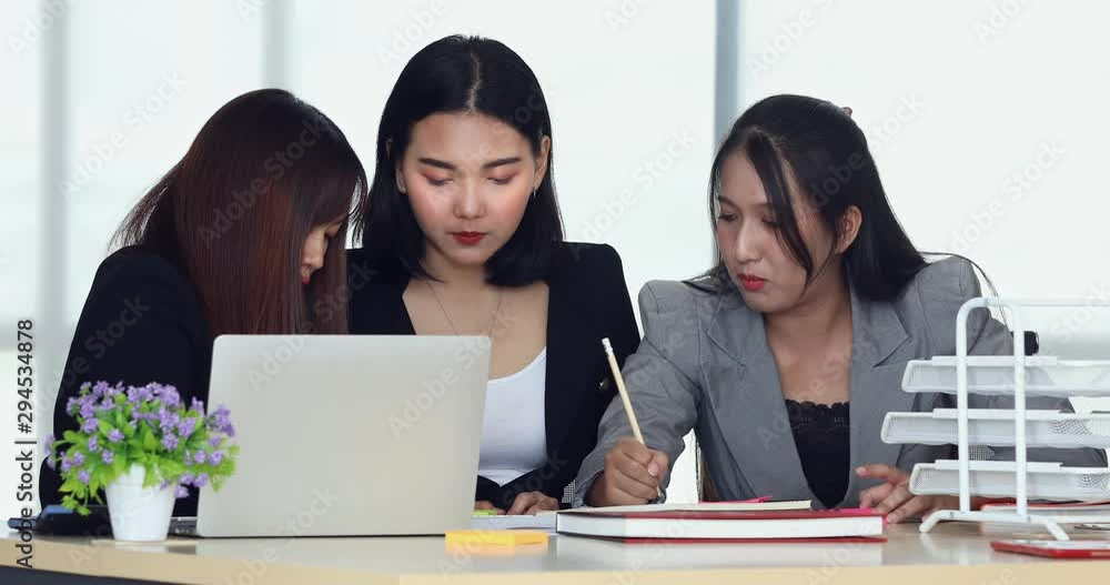 Group of young Asian businesswoman doing their work together preparing for next meeting. Group of young Asian businesswoman doing their work together preparing for next meeting.