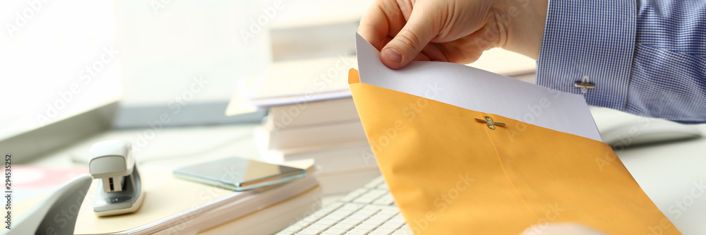 Businessman hold hand yellow mail envelope inbox post concept background - obrazy, fototapety, plakaty 