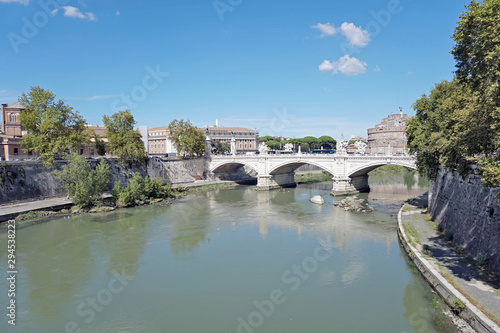 View to the Tiber river embankment and the bridge of Victor Emmanuel the Second and the Saint Angel Castle in a distance in the Rome city in Italy