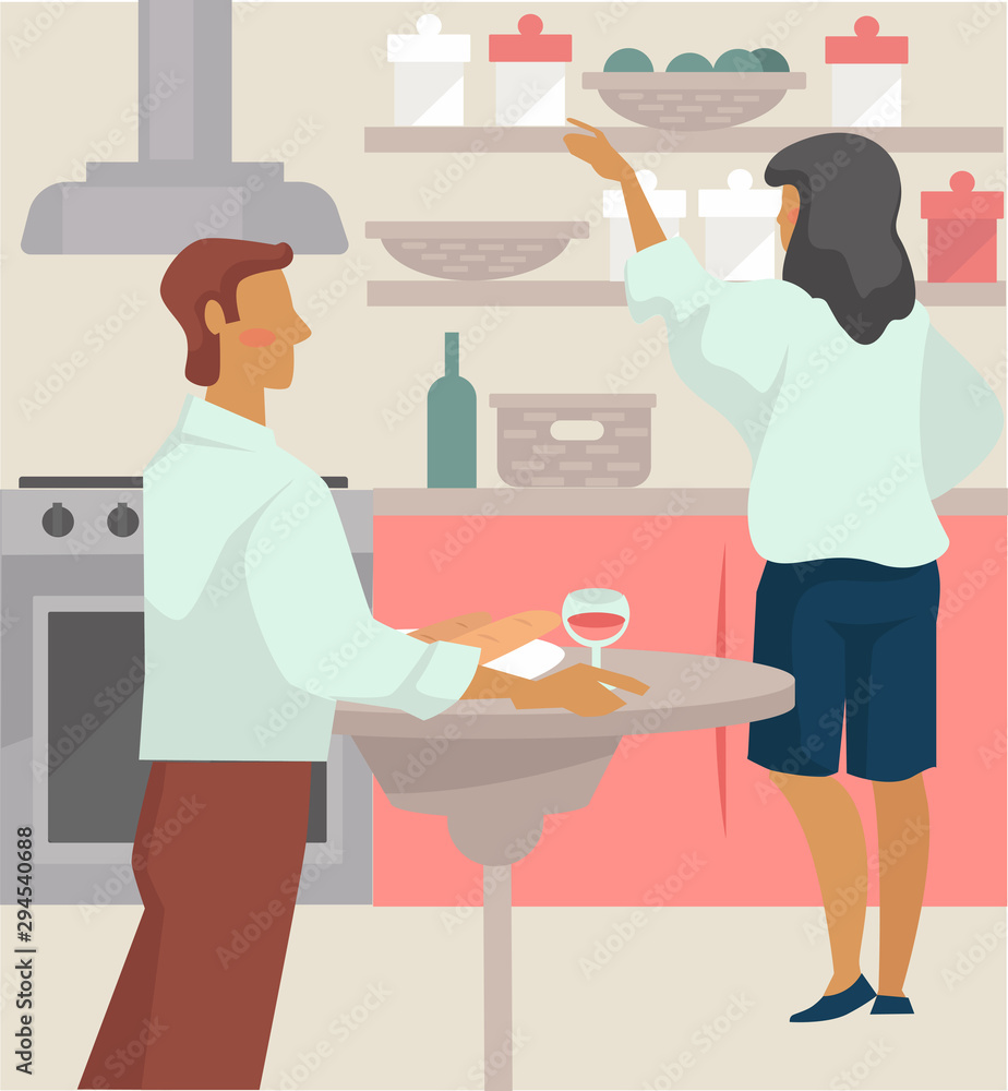 Couple have glass of wine and prepare dinner in kitchen Couple have glass of wine and prepare dinner in kitchen