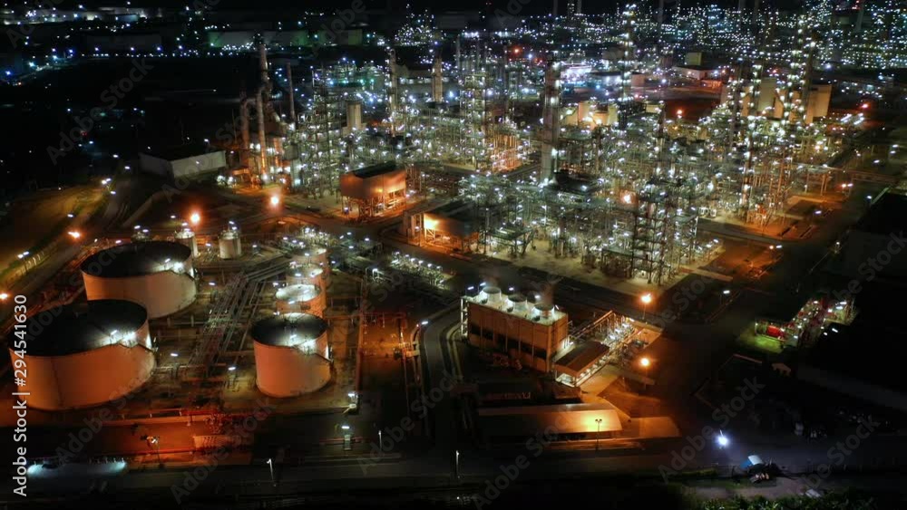 Aerial view night light oil terminal is industrial facility for storage of oil and petrochemical. oil manufacturing products ready for transport and business transportation. power electric plant. Aerial view night light oil terminal is industrial facility for storage of oil and petrochemical. oil manufacturing products ready for transport and business transportation. power electric plant.